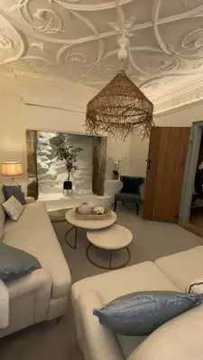 a living room with couches and a chandelier at Merchants House in Penryn