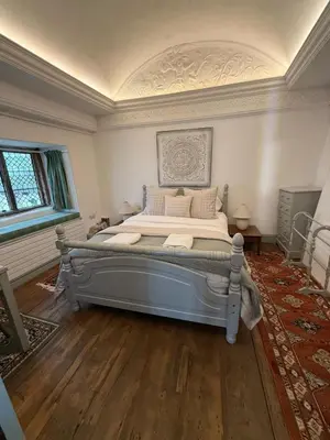 a bedroom with a large bed in a room at Merchants House in Penryn