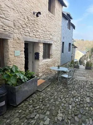 a stone patio with a table in front of a building at Merchants House in Penryn