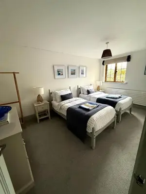 a living room with two beds and a couch at Merchants House in Penryn