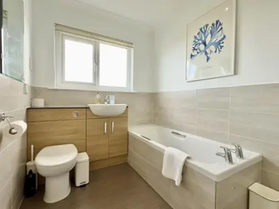 a bathroom with a toilet and a sink and a tub at 1 Netherton in Padstow