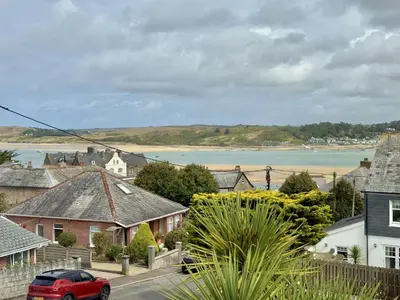 a red car parked on a street in a town with a body of water at 1 Netherton in Padstow