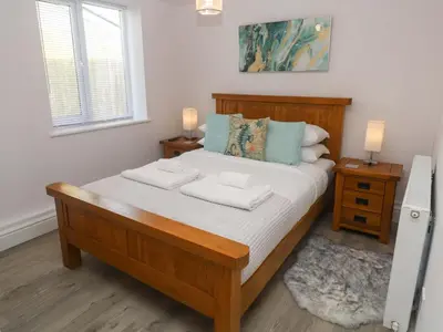 a bedroom with a large bed with two towels on it at St Marys in Penzance