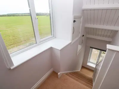 a room with a window and a stair case at St Marys in Penzance