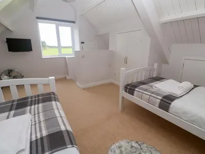 a bedroom with two beds and a window at St Marys in Penzance