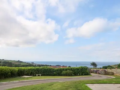 a road with the ocean in the background at St Marys in Penzance