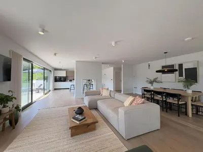 a living room with a couch and a table at Skyfall in Downderry
