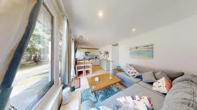 a living room with a couch and a large window at St Ives Kornel Hewel 2 Bedrooms in St Ives