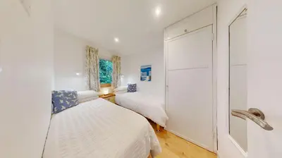 a bedroom with two beds and a window at St Ives Kornel Hewel 2 Bedrooms in St Ives