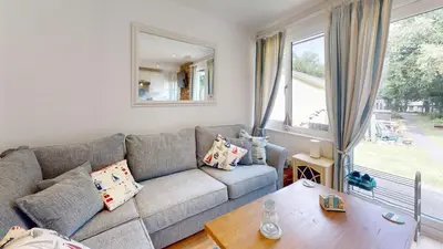 a living room with a couch and a table at St Ives Kornel Hewel 2 Bedrooms in St Ives
