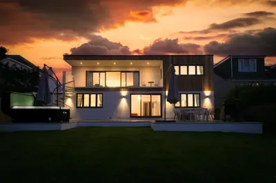 a house with a sunset in the background at Mor Glas in Carbis Bay