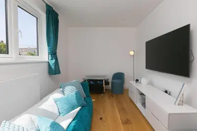a living room with a couch and a flat screen tv at Mor Glas in Carbis Bay
