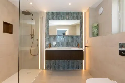 a bathroom with a tub and a sink and a mirror at Mor Glas in Carbis Bay
