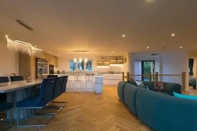 a kitchen and living room with a couch and a bar at Mor Glas in Carbis Bay