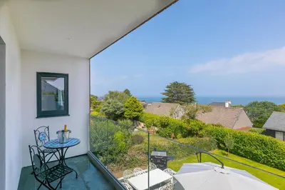 a balcony with a table and chairs and a view at Mor Glas in Carbis Bay