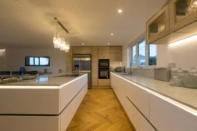 a large kitchen with white counters and a counter top at Mor Glas in Carbis Bay