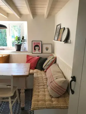 a room with a couch with pillows on the floor at April Cottage in Saint Erth