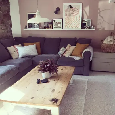 a living room with a blue couch and a wooden coffee table at April Cottage in Saint Erth