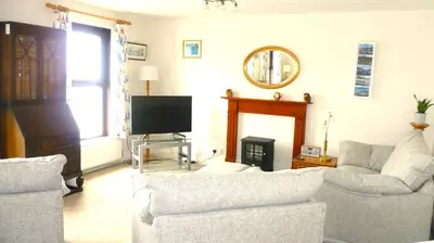 a living room with two couches and a television at 9 Rock Towers in Looe