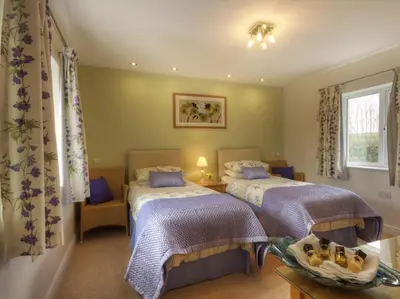 a bedroom with two beds and a window at Copper Meadow in Launceston