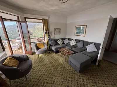 a living room with a couch and chairs in a room at Cowrie, New Polzeath in Wadebridge