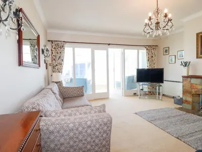 a living room with a couch and a tv at Pipers in Newquay