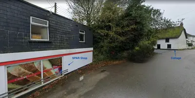 a side view of a house with the side of a building at Harvest Cottage in Constantine