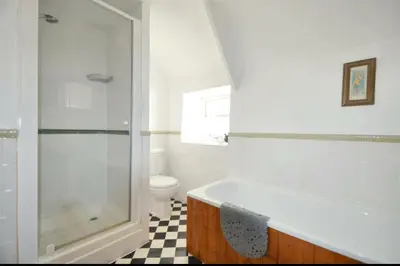 a bathroom with a shower and a tub and a toilet at Harvest Cottage in Constantine