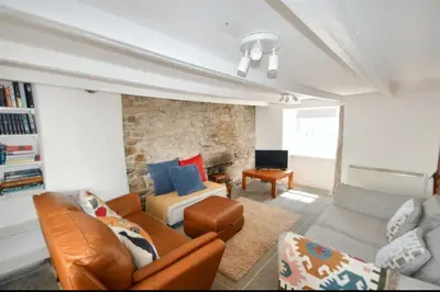 a living room with a couch and a chair at Harvest Cottage in Constantine