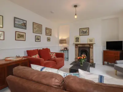 a living room with a couch and a fireplace at 84 Fore Street in Port Isaac