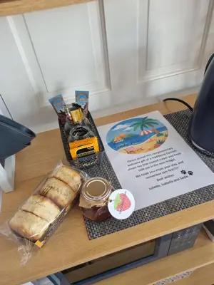 a table with a tray of food and bread on it at Sandy Paws in Portreath