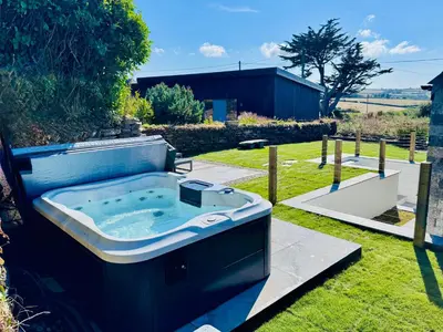 a bath tub sitting in the grass in a yard at Penheyl, Tregonce near Padstow and Sea in St. Issey
