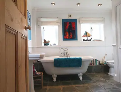 a bathroom with a tub and a sink and a toilet at Single room, close to beaches and Eden Project in Tywardreath