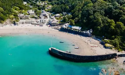 an aerial view of a beach with a boat in the water at Single room, close to beaches and Eden Project in Tywardreath