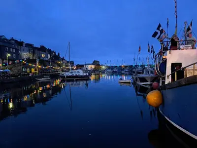 a group of boats docked in a harbor at night at Bell Tent 2 in St Austell
