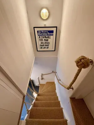 a staircase in a building with a sign on the wall at Peaceful Cornish Retreat - Sleeps 6 in Wadebridge