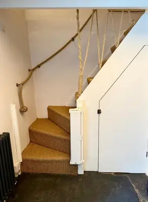 a set of stairs in a house with a white door at Peaceful Cornish Retreat - Sleeps 6 in Wadebridge