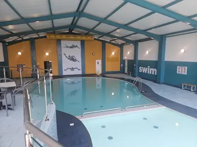 a large swimming pool in a gym with a swimming pool at Emma and Simon's hideaway Retreat in Polperro
