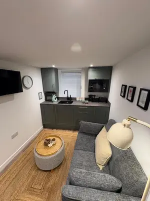 a living room with a couch and a table at Bagnalls Studio, a newly renovated studio in a traditional fisherman's cottage in St Ives