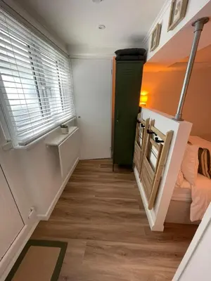 a room with a staircase with a green door at Bagnalls Studio, a newly renovated studio in a traditional fisherman's cottage in St Ives