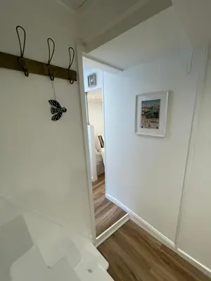 a hallway with a butterfly hanging on a wall at Bagnalls Studio, a newly renovated studio in a traditional fisherman's cottage in St Ives