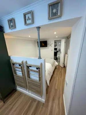 a small bedroom with a bed in a room at Bagnalls Studio, a newly renovated studio in a traditional fisherman's cottage in St Ives
