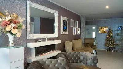 a living room with a fireplace and a mirror at The Feather's Hotel Newquay in Newquay