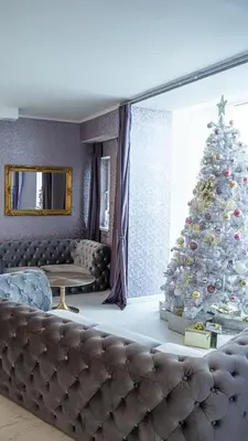 a living room with a christmas tree and a couch at The Feather's Hotel Newquay in Newquay
