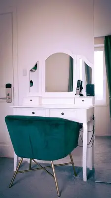 a desk with a green tub in front of a mirror at The Feather's Hotel Newquay in Newquay