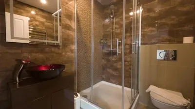 a bathroom with a glass shower with a toilet at The Feather's Hotel Newquay in Newquay