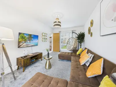 a living room with a couch and a table at Beachside Retreat by Signature Stays - Modern Coastal Home in Hayle