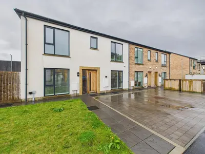 an empty parking lot in front of a house at Beachside Retreat by Signature Stays - Modern Coastal Home in Hayle
