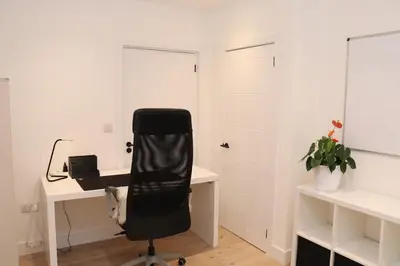 an office with a black chair sitting at a desk at The Hidden Sanctuary in Stithians