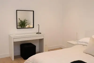 a bedroom with a fireplace with a mirror and a bed at The Hidden Sanctuary in Stithians